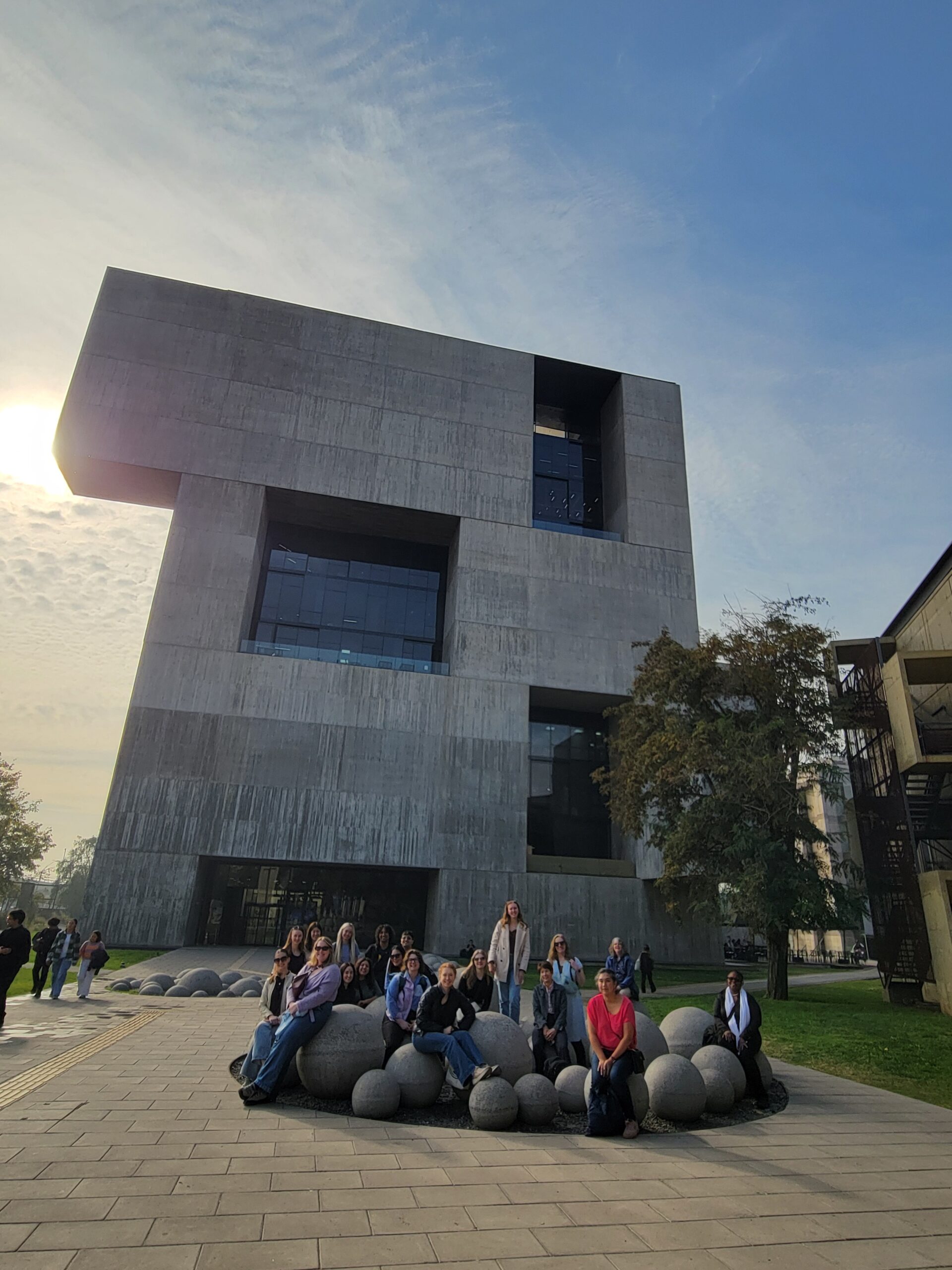 Group in front of building at Pontificia Universidad Catolica de Chile's San Joaquin campus